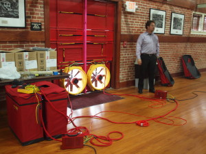 Setting up the whole building blower door test, 2nd floor historic gymnasium space, Lee H. Nelson Hall.